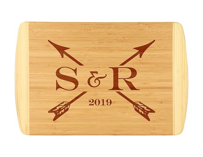 Initials & arrows custom bamboo cutting board is laser engraved with custom initials and established year.  Uniquely designed custom cutting board.