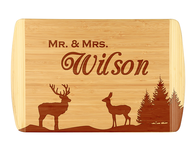 Unique buck, doe and tree bamboo cutting board.  Customize with your last name.  Laser engraved for detailed look and quality.